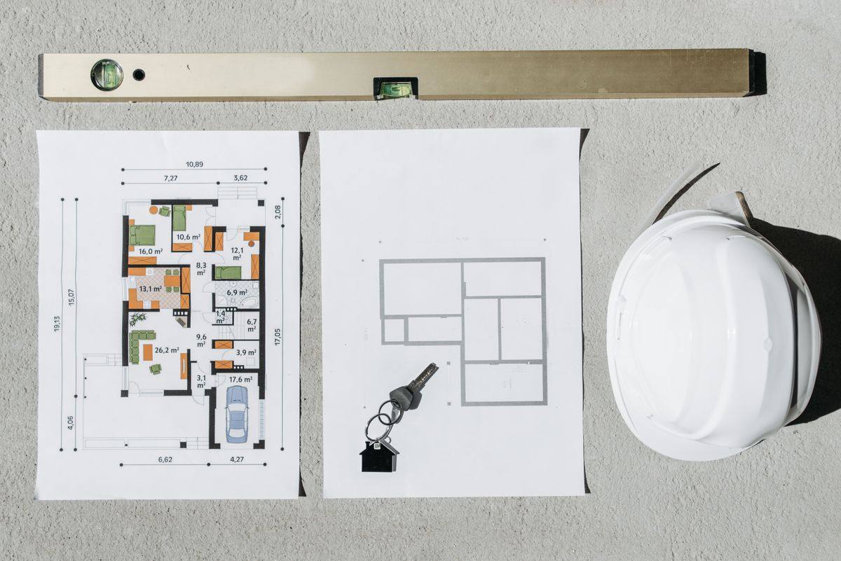 Construction planning: blueprints, level and hard hat
